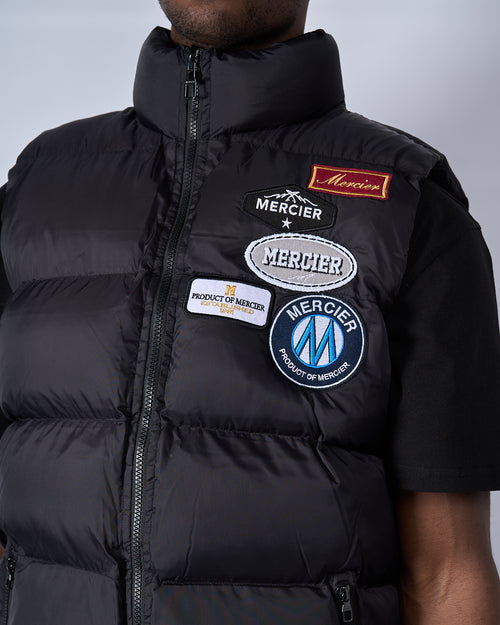 Gilet nero Mercier e distintivo